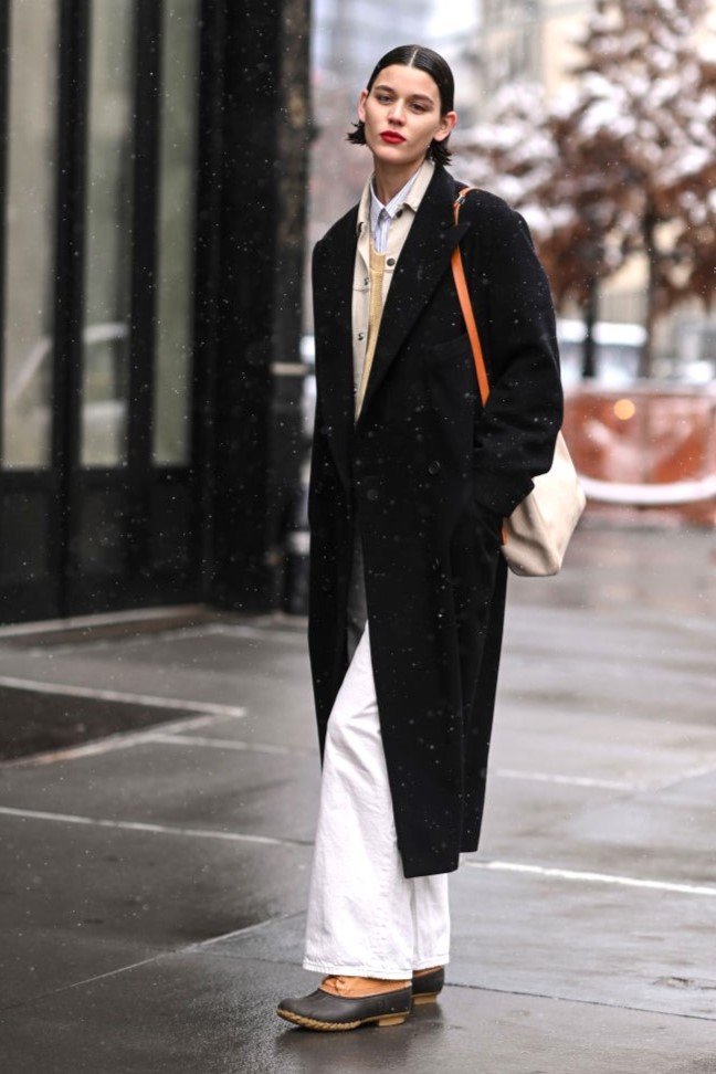 NEW YORK, NEW YORK - FEBRUARY 13: Model Vivienne Rohner is seen wearing a black coat, white pants and tan bag outside the Khaite show during New York Fashion Week A/W 2022 on February 13, 2022 in New York City. (Photo by Daniel Zuchnik/Getty Images)