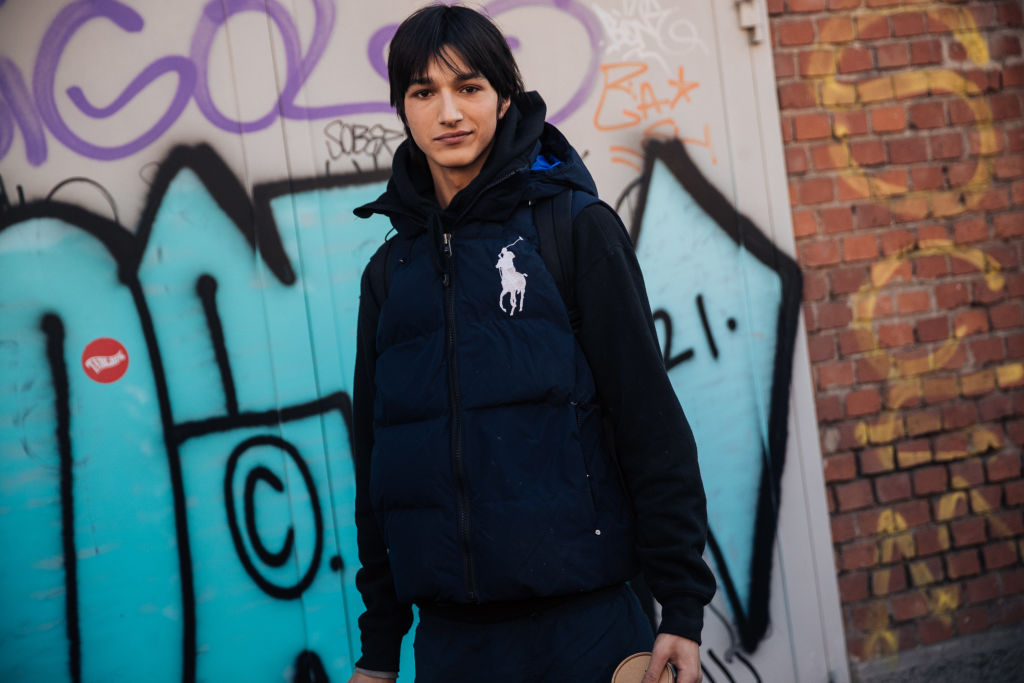 Model Rubuen Bilan-Carroll wears a Polo blue puffer vest outside the Fendi show during the Milan Men's Fashion Week 