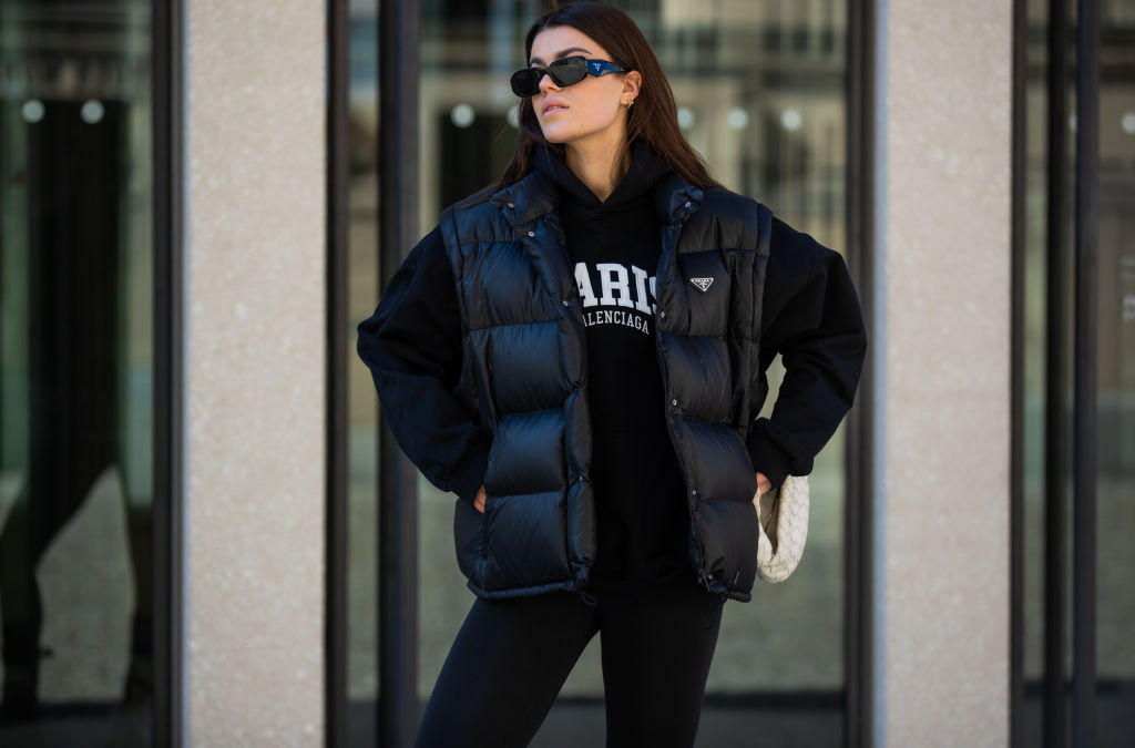 Enna is seen wearing black hoody Balenciaga, leggings Nike, Boots & white bag Bottega Veneta, sunglasses & vest Prada during Berlin Fashion Week on March 15, 2022 in Berlin, Germany. 