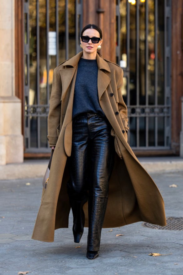 BARCELONA, SPAIN - JANUARY 09: Zina Charkoplia wears black sweater, pants, brown oversized double breasted coat by Frankie Shop, pointed boots by Proenza Schouler, grey YSL bag, Gigi Studios sunnies, earrings on January 09, 2024 in Barcelona, Spain. (Photo by Christian Vierig/Getty Images)