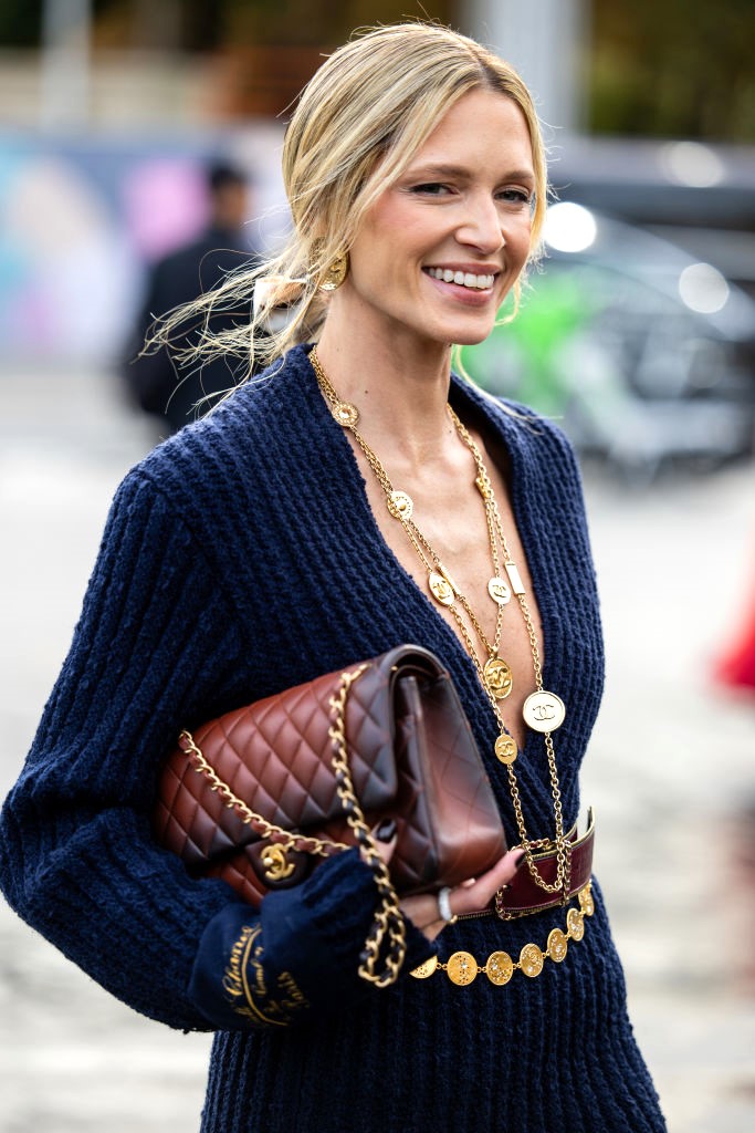 PARIS, FRANCE - OCTOBER 01: Helena Bordon wears necklace with logo navy knit, brown bag outside Chanel during Womenswear Spring/Summer 2025 as part of Paris Fashion Week on October 01, 2024 in Paris, France. (Photo by Christian Vierig/Getty Images)